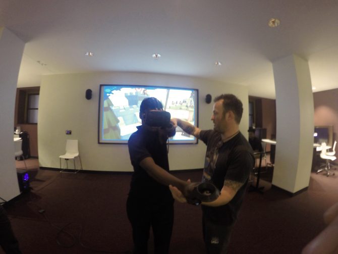 A library staff member shows a patron how to use a virtual reality headset